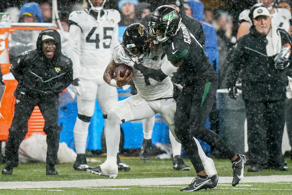 Jacksonville Jaguars running back Travis Etienne Jr. (1) is tackled by New York Jets cornerback Sauce Gardner (1) during the second quarter of an NFL football game, Thursday, Dec. 22, 2022, in East Rutherford, N.J. (AP Photo/Frank Franklin II)