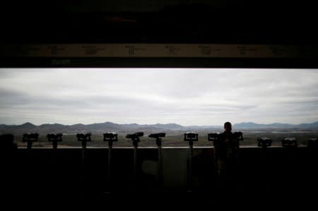 A man stands near binoculars as he tries to see North Korea's propaganda village of Gijungdong at the Dora observatory near the demilitarised zone separating the two Koreas, in Paju, South Korea, April 24, 2018. REUTERS/Kim Hong-Ji