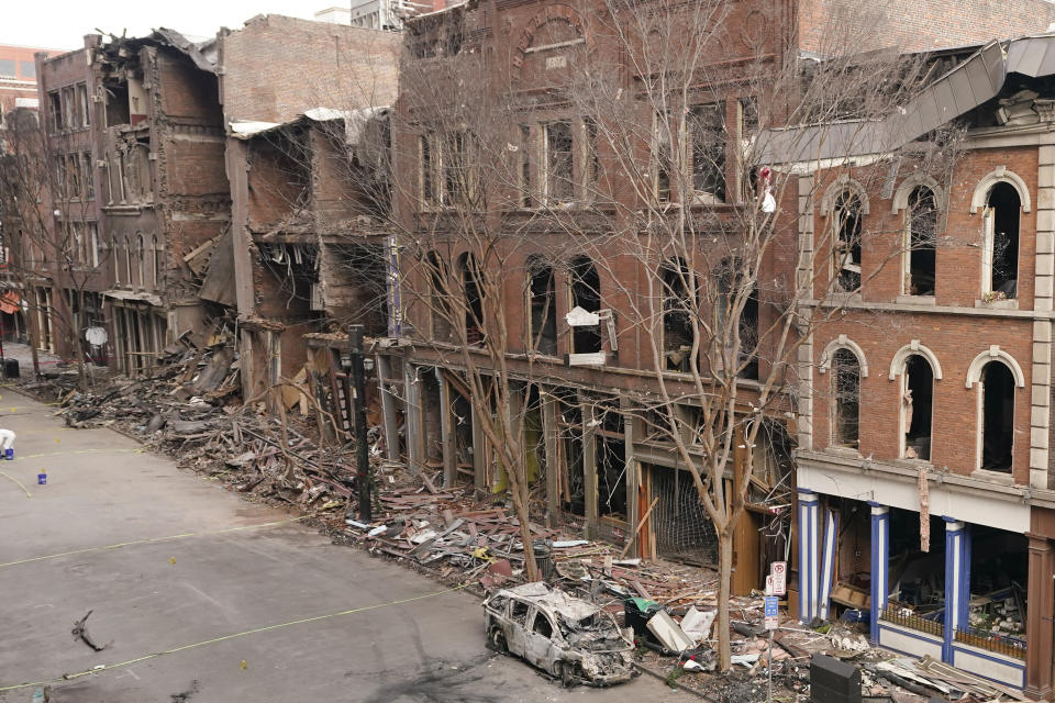 A vehicle destroyed in a Christmas Day explosion remains on the street Tuesday, Dec. 29, 2020, in Nashville, Tenn. Officials have named 63-year-old Anthony Quinn Warner as the man behind the bombing in which he was killed, but the motive has remained elusive. (AP Photo/Mark Humphrey)