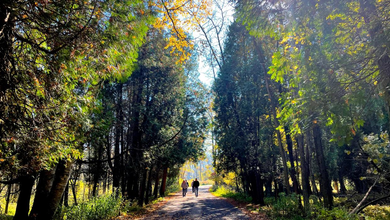 People walk on a path at Harrington Beach State Park in Belgium on Oct. 22, 2022.