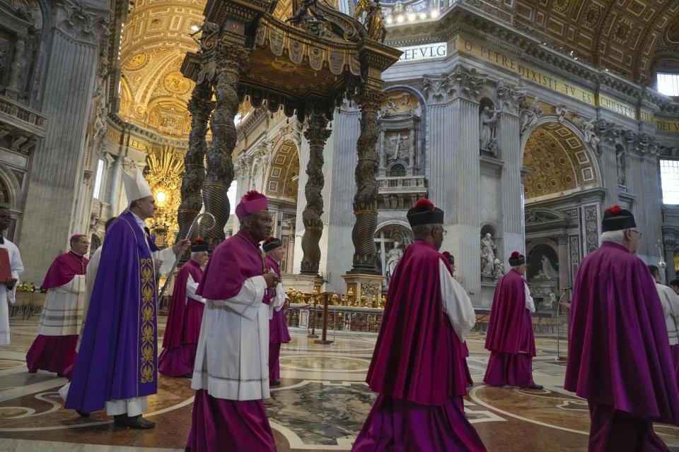 Cardinal Mauro Bassetti, left, arrives to celebrate a penitential rite in front of the altar of the confession inside St. Peter's Basilica, Saturday, June 3, 2023. (AP Photo/Gregorio Borgia)