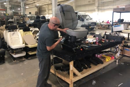 An assembly line worker works on the production line at Midwest Automotive Designs in Bristol, Indiana