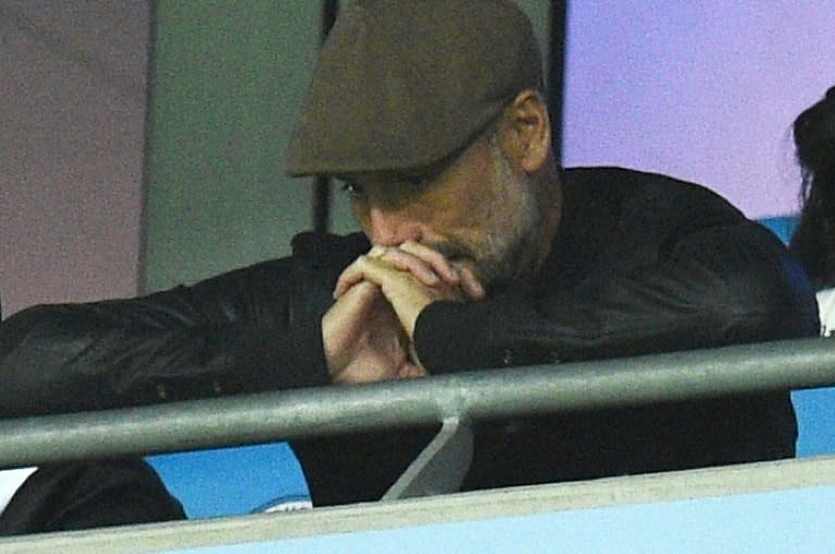 Manchester City manager Pep Guardiola watches his team's Champions League match against Lyon from the stands at the Etihad stadium