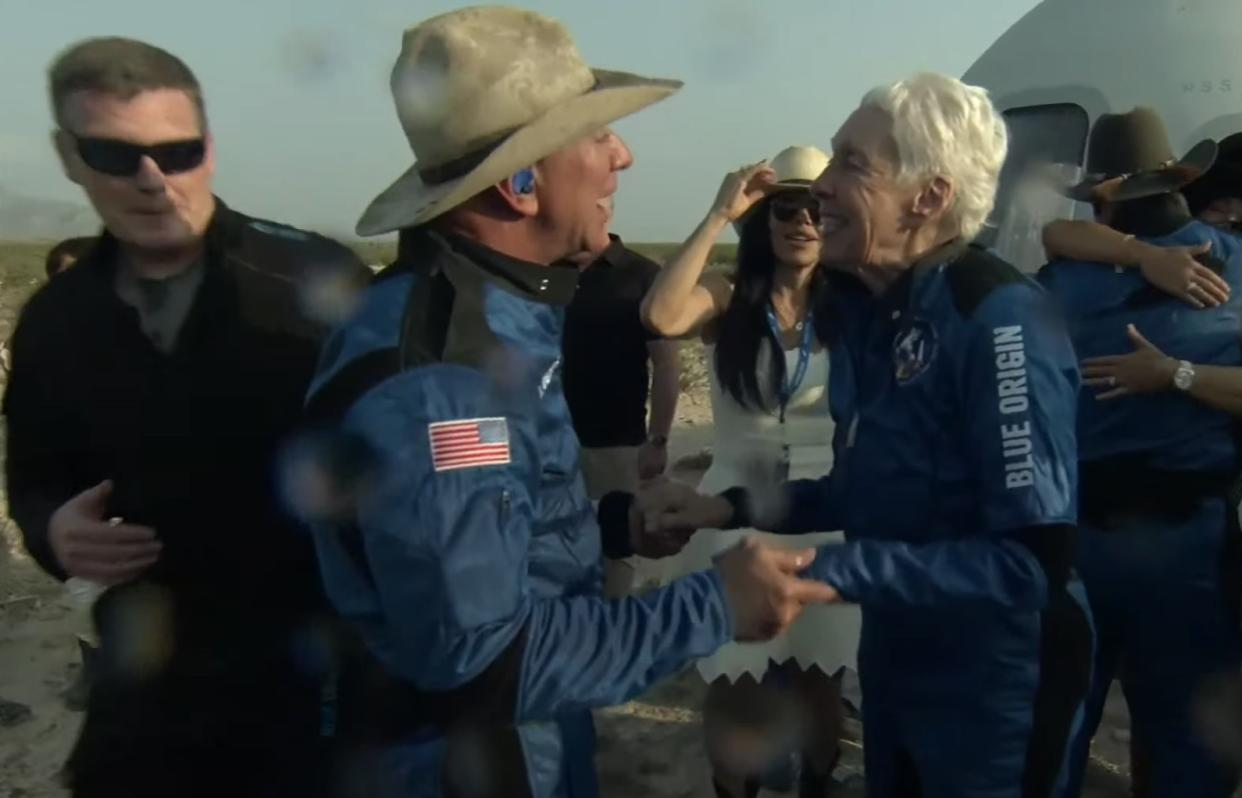 Jeff Bezos along with his brother Mark, Oliver Daemen, and Wally Funk leave the New Shepard crew capsule after returning from space on July 20, 2021 in Van Horn, Texas. (Photo by Blue Origin/Anadolu Agency via Getty)