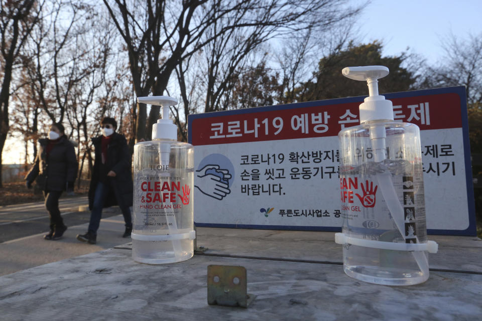 Bottles of hand sanitizer are displayed for use at a park in Goyang, South Korea, Friday, Dec. 4, 2020. The Korea Disease Control and Prevention Agency said Friday that 600 of the newly confirmed patients were domestically transmitted cases — nearly 80 % of them in the densely populous Seoul area, which has been at the center of a recent viral resurgence. The notice reads: "The COVID-19 prevention hand sanitizer." (AP Photo/Ahn Young-joon)