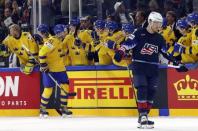 Ice Hockey - 2018 IIHF World Championships - Semifinals - Sweden v USA - Royal Arena - Copenhagen, Denmark - May 19, 2018 - Magnus Paajarvi of Sweden celebrates with team mates after scoring a goal while Dylan Larkin of the U.S. looks dejected. REUTERS/Grigory Dukor