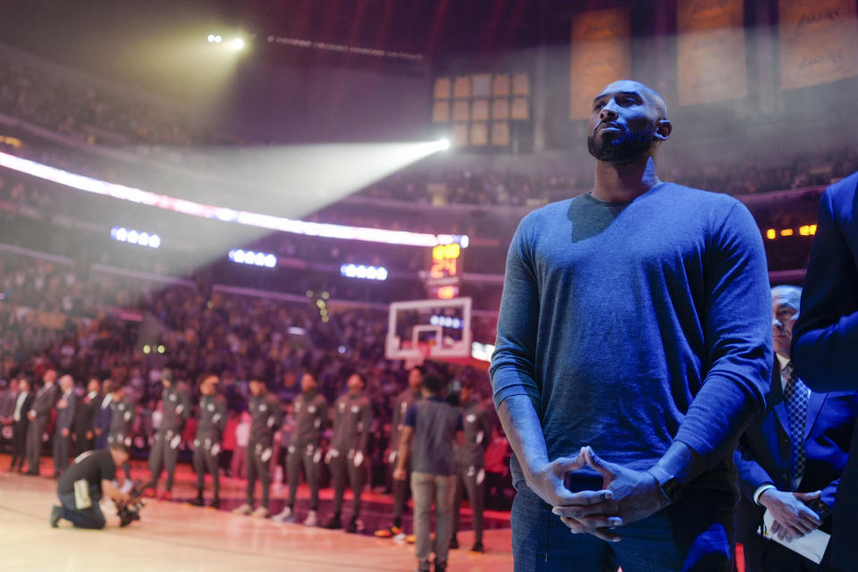 Former Los Angeles Lakers Kobe Bryant listens to the national anthem prior to an NBA basketball game between Los Angeles Lakers and Atlanta Hawks, Sunday, Nov. 17, 2019, in Los Angeles. The Lakers won 122-101. (AP Photo/Ringo H.W. Chiu)