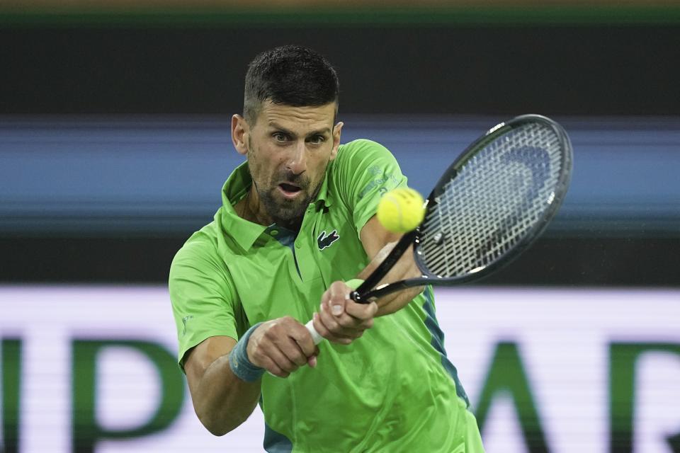 Novak Djokovic, of Serbia, returns a shot Luca Nardi, of Italy, at the BNP Paribas Open tennis tournament Monday, March 11, 2024, in Indian Wells, Calif. Nardi won 6-4, 3-6, 6-3. (AP Photo/Mark J. Terrill)