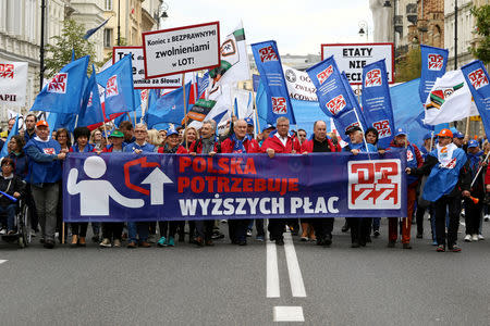 People take part in an anti-government demonstration of public-sector trade unions demanding higher wages in Warsaw, Poland September 22, 2018. The banner reads, "Poland needs higher wages." Agencja Gazeta/Slawomir Kaminski via REUTERS