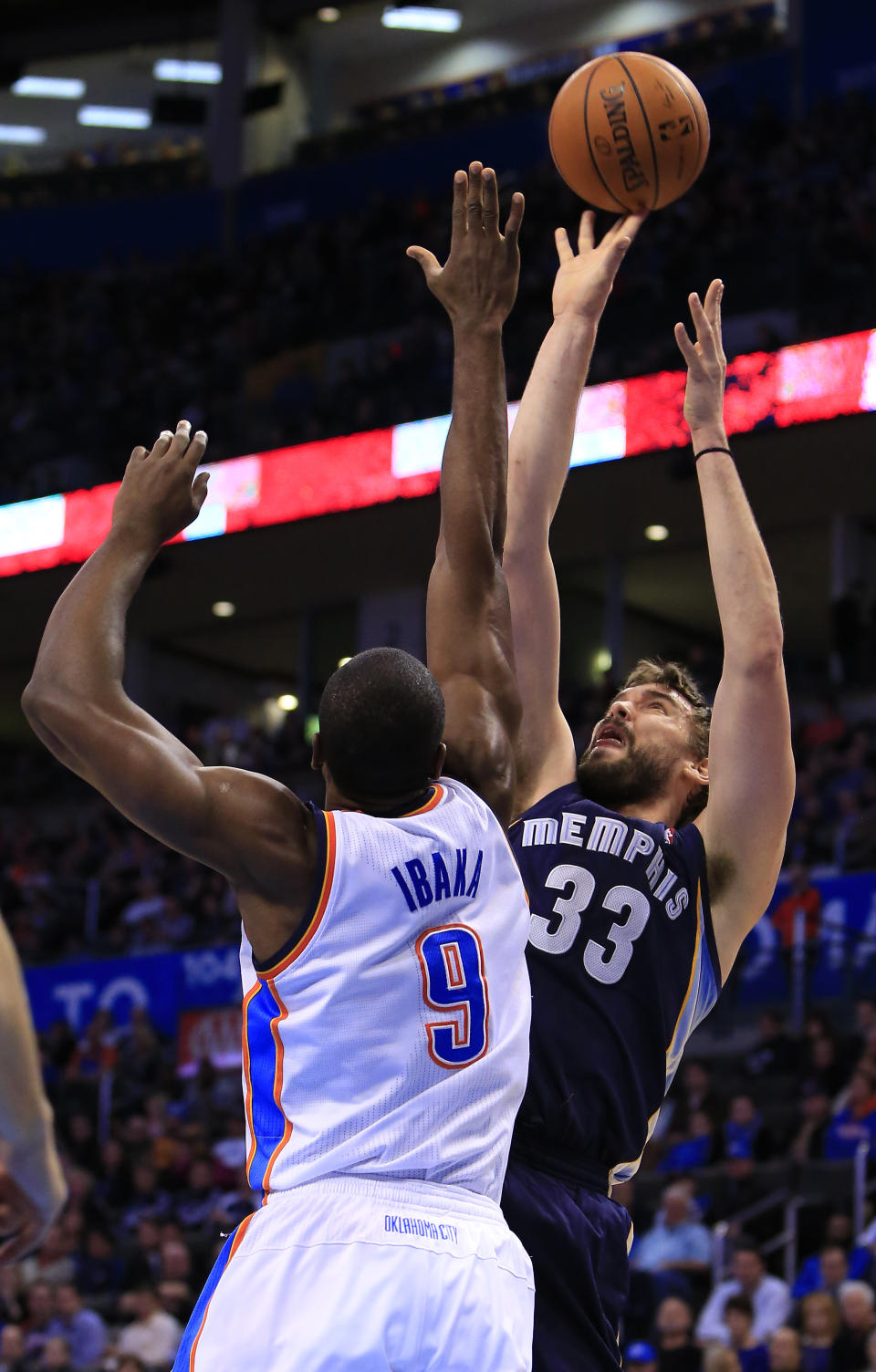 Memphis Grizzlies center Marc Gasol (33) shoots over Oklahoma City Thunder forward Serge Ibaka (9) during the second quarter of an NBA basketball game on Monday, Feb. 3, 2014, in Oklahoma City. (AP Photo/Alonzo Adams)