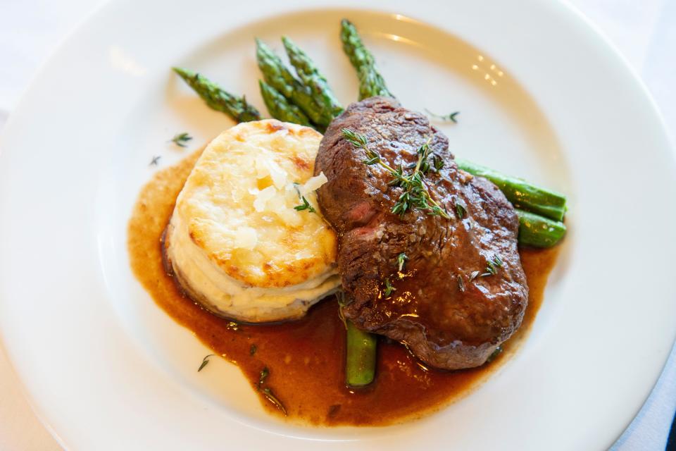 The Mimi's Table filet mignon is a 6 ounce premium black Angus filet served with potato gratin, grilled asparagus and red wine demi. 