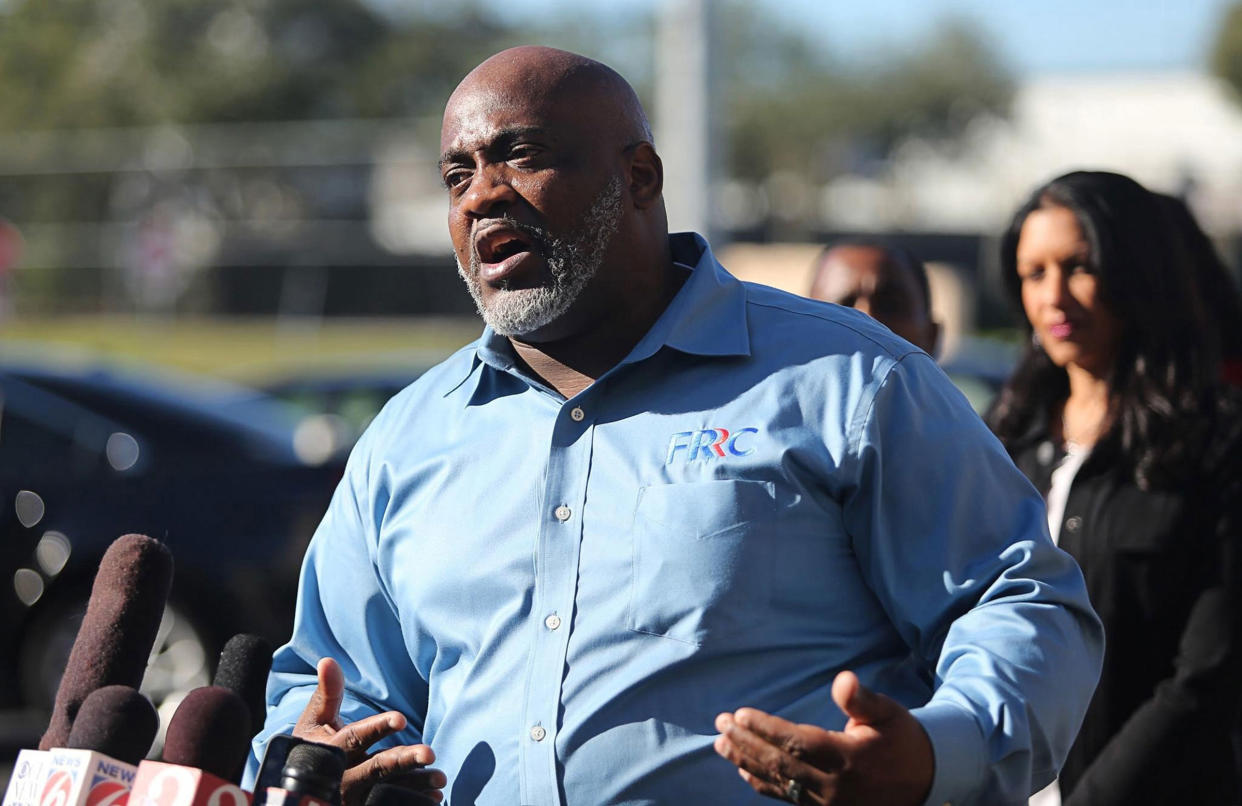 Desmond Meade, president of the Florida Rights Restoration Coalition, holds a news conference in front of the Orange County Supervisor of Elections