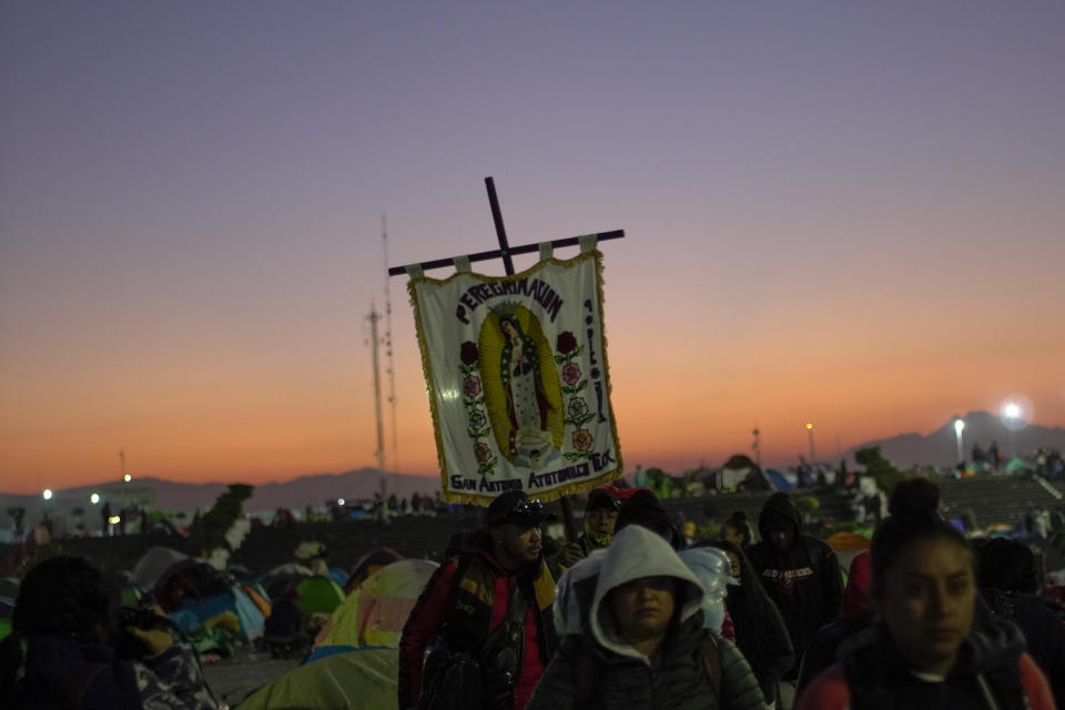 Pilgrims carrying icons of the Virgin of Guadalupe arrive at the Basilica of Guadalupe in Mexico City, early Monday, Dec. 12, 2022. Devotees of the Virgin of Guadalupe make the pilgrimage for her Dec. 12 feast day, the anniversary of one of several apparitions of the Virgin Mary witnessed by an Indigenous Mexican man named Juan Diego in 1531. (AP Photo/Aurea Del Rosario)