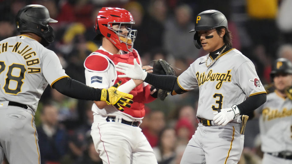 Pittsburgh Pirates' Ji Hwan Bae, right, is congratulated by Canaan Smith-Njigba after his two run, home run during the second inning of a baseball game against the Boston Red Sox at Fenway Park, Tuesday, April 4, 2023, in Boston. At center is Boston Red Sox catcher Reese McGuire. (AP Photo/Charles Krupa)