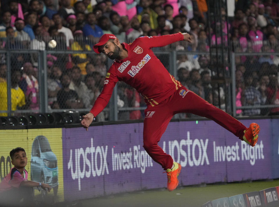 Punjab Kings' Sikandar Raza jumps take a catch on the boundary line during the Indian Premier League (IPL) 2023 match between Punjab Kings and Rajasthan Royals, in Guwahati, India, Wednesday, April 5, 2023. (AP Photo/Anupam Nath)