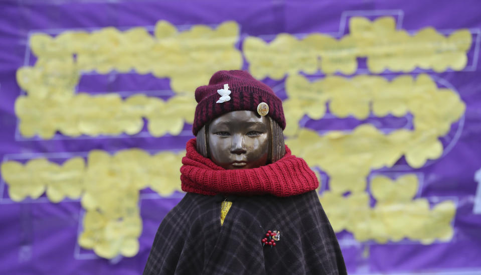 FILE - In this Dec. 28, 2017, file photo, a statue representing sex slaves is seen near the Japanese Embassy in Seoul, South Korea. South Korea says it will dissolve a foundation funded by Japan to compensate South Korean women who were forced to work in Japan's World War II military brothels. Seoul's Ministry of Gender Equality and Family said Wednesday, Nov. 21, 2018, it will take legal steps to dissolve the foundation. The letters read "Nullity". (AP Photo/Lee Jin-man, File)