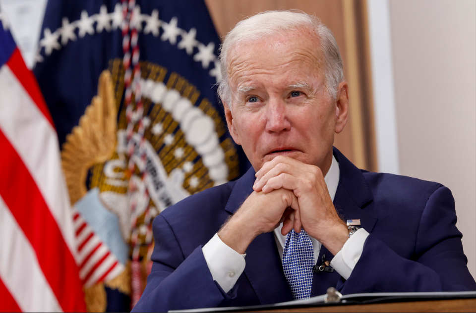 Biden sitting at a desk