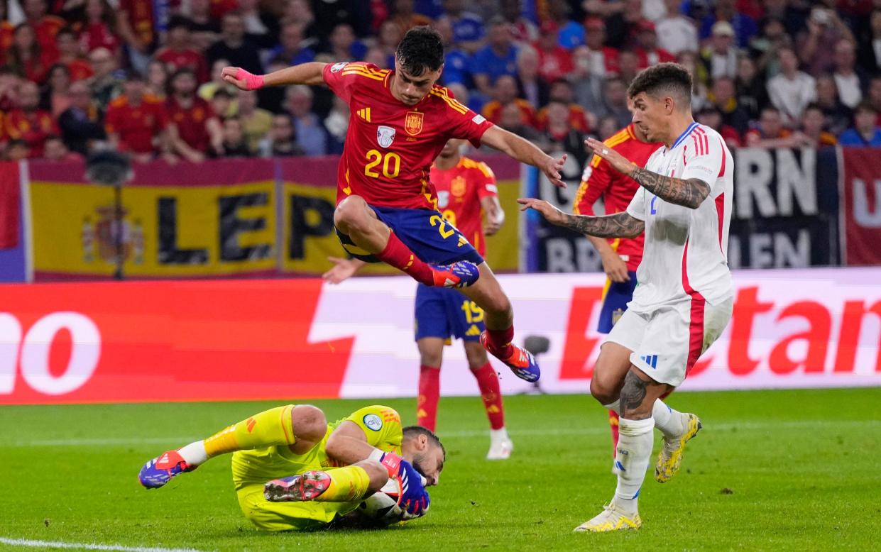 Gianluigi Donnarumma dives at the feet of Pedri.