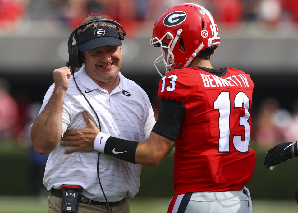 ATHENS, GA - OCTOBER 02: Stetson Bennett #13 of the Georgia Bulldogs reacts with head coach Kirby Smart in the second half against the Arkansas Razorbacks at Sanford Stadium on October 2, 2021 in Athens, Georgia. (Photo by Todd Kirkland/Getty Images)