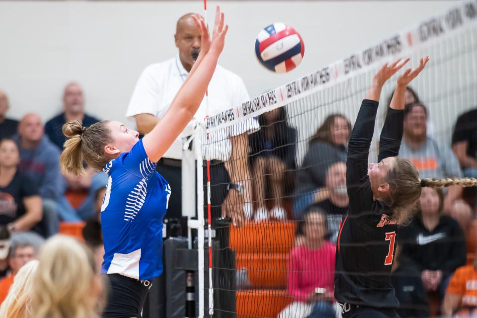 Spring Grove junior outside hitter McKenzie Boyer, left, hits the ball over the net as Central York's Taryn Peters (7) tries to block during a YAIAA Division I volleyball match at Central York High School on Thursday, September 22, 2022. The Panthers won in three sets; 25-21, 25-22, 25-23.