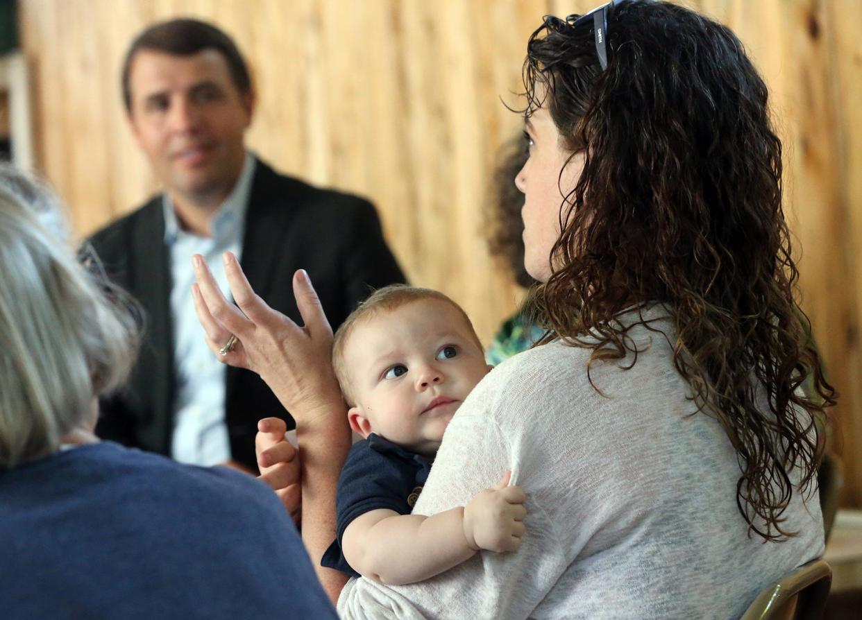 Jamie Clavet of Barrington holds her son, Owen Limberger, as she speaks to Rep. Chris Pappas, D-New Hampshire, about the burden of childcare cost and availability Tuesday, Aug. 22, 2023 at Acorn School in Stratham.