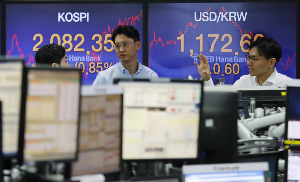 Currency traders work at the foreign exchange dealing room of the KEB Hana Bank headquarters in Seoul, South Korea, Tuesday, Oct. 22, 2019. Shares are gaining in Asia after upbeat comments from President Donald Trump and other U.S. officials on the status of trade negotiations with China. (AP Photo/Ahn Young-joon)