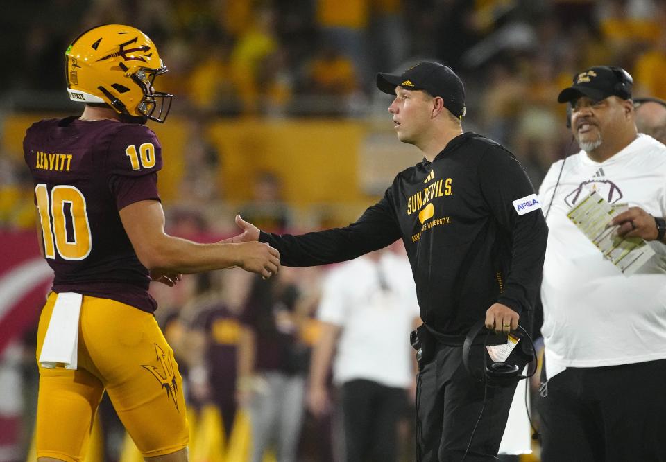 ASU head coach Kenny Dillingham greets quarterback Sam Leavitt (10) during a game against Wyoming at Sun Devil Stadium in Tempe on Aug. 31, 2024.