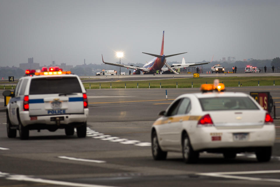 A southwest airlines plane rests on the tarmac after what officials say was a nose gear collapse during a landing at LaGuardia Airport, Monday, July 22, 2013, in New York. The Federal Aviation Administration says the plane landed safely. (AP Photo/John Minchillo)