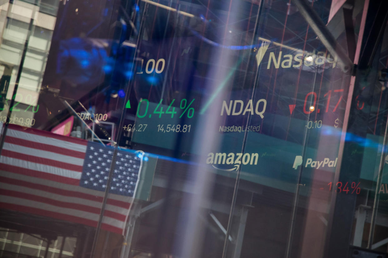 reflections in screen showing stock market information at the Nasdaq MarketSite in New York