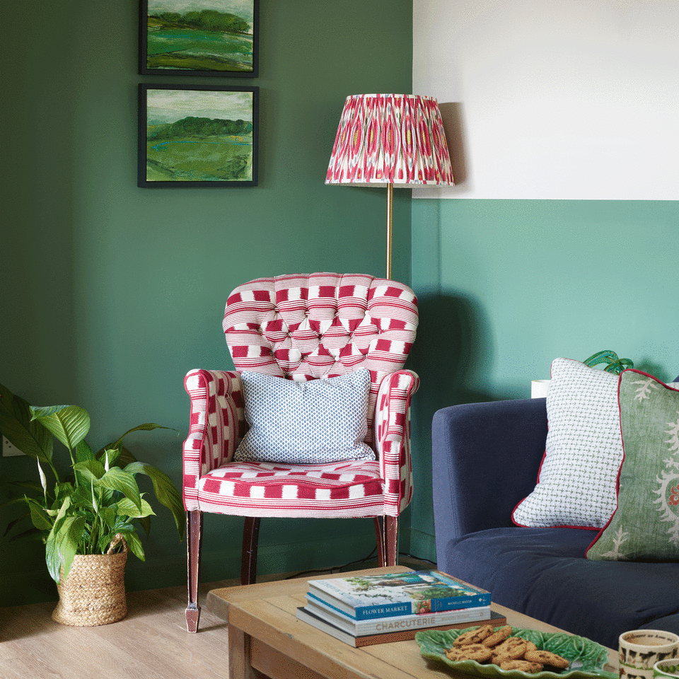 Green living room with pink armchair