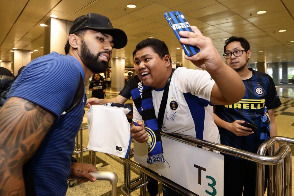 <p>A fan takes a selfie with Gabriel Barbosa (L) of Inter Milan </p>