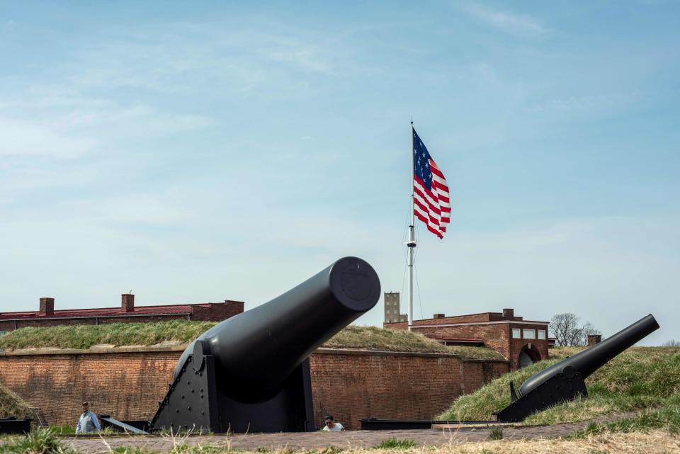 A historical American flag flies over Fort McHenry in Baltimore on March 30, 2019, as tourists visit the historical monument.