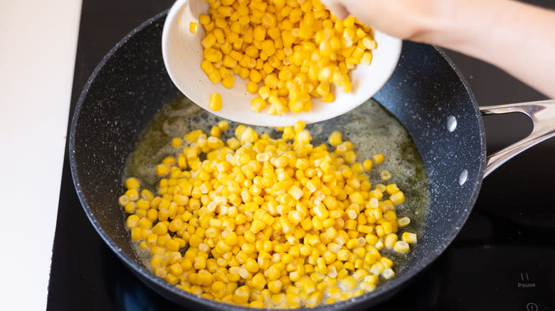 corn pouring into pan