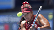 Naomi Osaka, of Japan, plays against Saisai Zheng, of China, during the first round of the tennis competition at the 2020 Summer Olympics, Sunday, July 25, 2021, in Tokyo, Japan. (AP Photo/Seth Wenig)