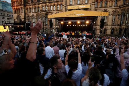 People watch a choir concert on the first anniversary of the Manchester Arena bombing, in Manchester, Britain, May 22, 2018. REUTERS/Andrew Yates