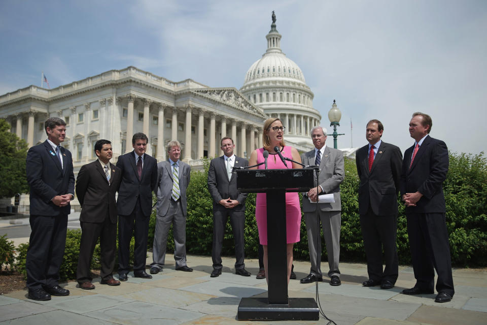 Sinema joins a group of bipartisan Congressmen during a news conference in 2014. (Photo: Chip Somodevilla/Getty Images)