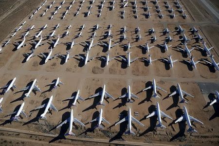 Old airplanes, including Boeing 747-400s, are stored in the desert in Victorville, California March 13, 2015. REUTERS/Lucy Nicholson