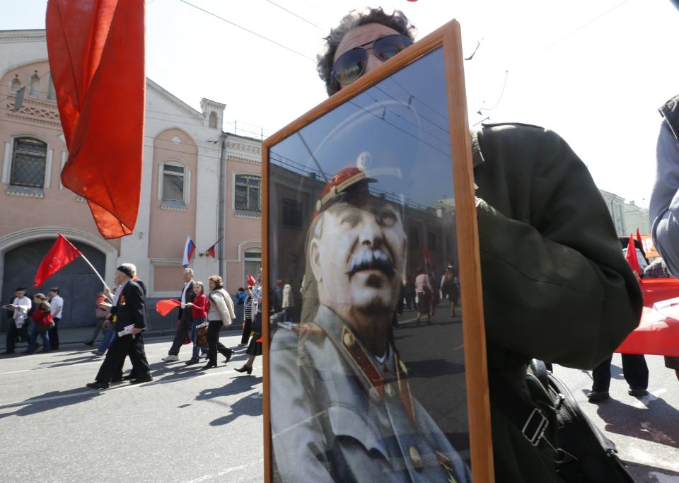 A member of Russia's Communist party carries a portrait of Soviet leader Joseph Stalin during a May Day rally in Moscow May 1, 2014. Russians celebrate the coming of Spring and since communist times, Labour Day on the first day of May. (REUTERS/Sergei Karpukhin)