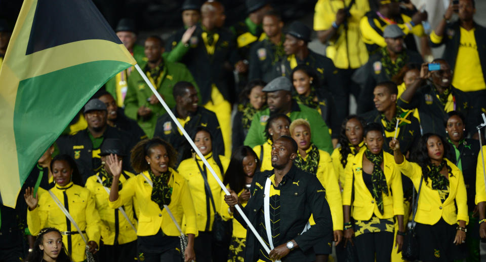 Jamaica&#39;s flagbearer Usain Bolt leads his delegation during the opening ceremony of the London 2012 Olympic Games in the Olympic Stadium in London on July 27, 2012.    AFP PHOTO / CHRISTOPHE SIMON        (Photo credit should read CHRISTOPHE SIMON/AFP/GettyImages)