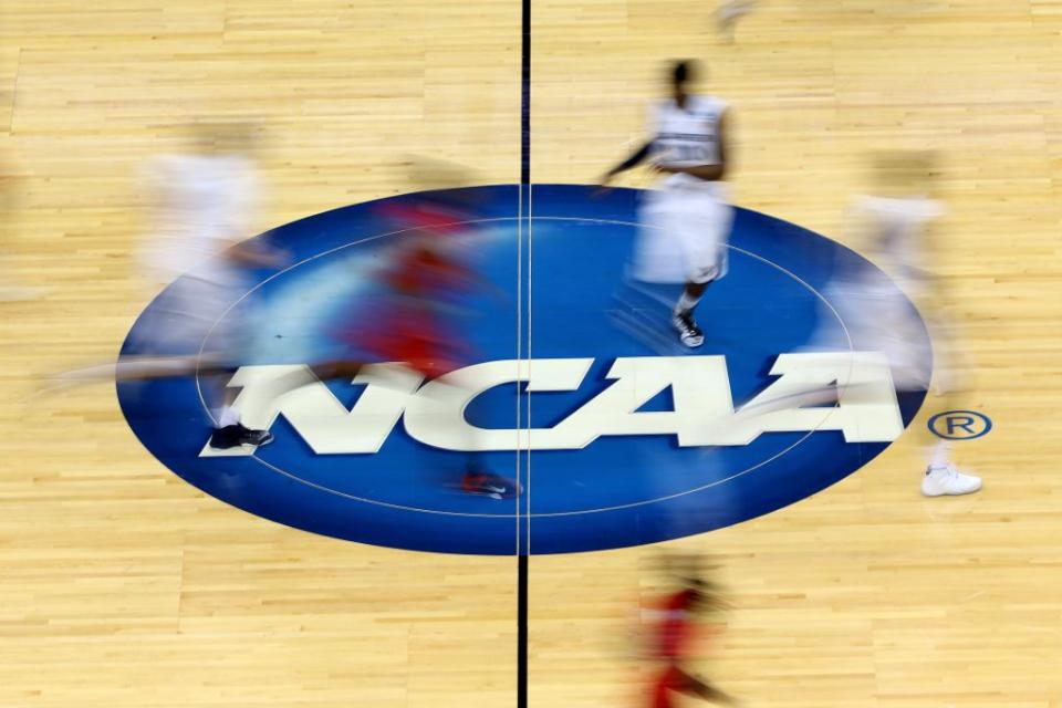 Mississippi Rebels and Xavier Musketeers players run by the logo at mid-court during the second round of the 2015 NCAA Men’s Basketball Tournament at Jacksonville Veterans Memorial Arena on March 19, 2015 in Jacksonville, Florida. (Photo by Mike Ehrmann/Getty Images)