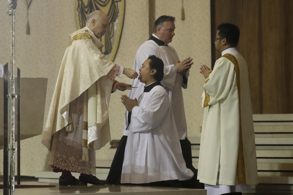 FILE - In this Sunday, April 12, 2020 file photo, San Francisco Archbishop Salvatore Cordileone, left, celebrates Communion during Easter Mass, which was live streamed, at St. Mary's Cathedral in San Francisco. Cordileone hopes his fellow bishops, at their upcoming national meeting in June 2021, will agree to send a strong message of disapproval to Catholic politicians who advocate for abortion rights. (AP Photo/Jeff Chiu)