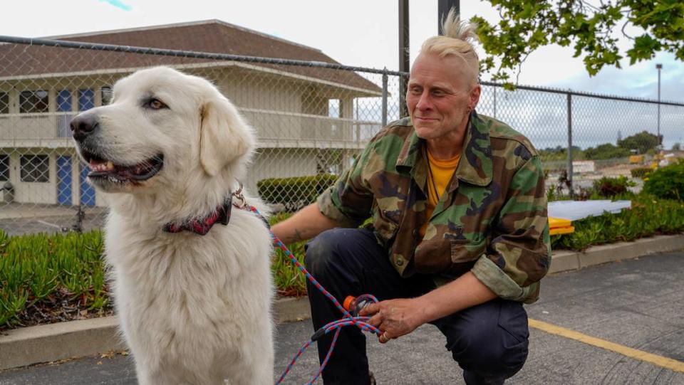 Nicholas Touvell, a homeless South County resident, and his dog Amora wait to receive food and clothing at a donation event hosted by First Baptist Nipomo. The church conducts monthly outreach and donation efforts with South County’s homeless population, where unhoused residents can stock up on clothing and other essentials.