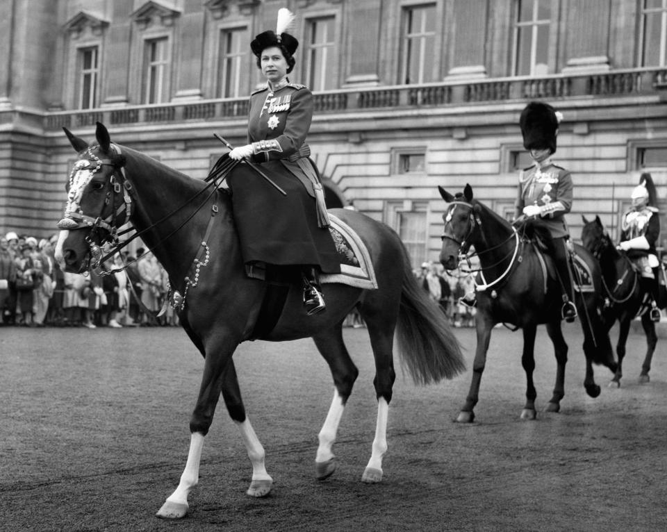 FILE - Britain's Queen Elizabeth II, rides out from Buckingham Palace to take the salute at the ceremony of Trooping the Colour, followed by Prince Philip and the Duke of Gloucester, the Queen's uncle, in London, June 15, 1960. Queen Elizabeth II will mark 70 years on the throne Sunday, Feb. 6, 2022, an unprecedented reign that has made her a symbol of stability as the United Kingdom navigated an age of uncertainty. (AP Photo, File)