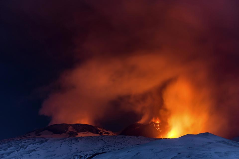 Snow-covered Mount Etna, Europe's most active volcano, spews lava during an eruption in the early hours of Thursday, March 16, 2017. A new eruption which began on March 15 is causing no damages to Catania's airport which is fully operational. (AP Photo/Salvatore Allegra)