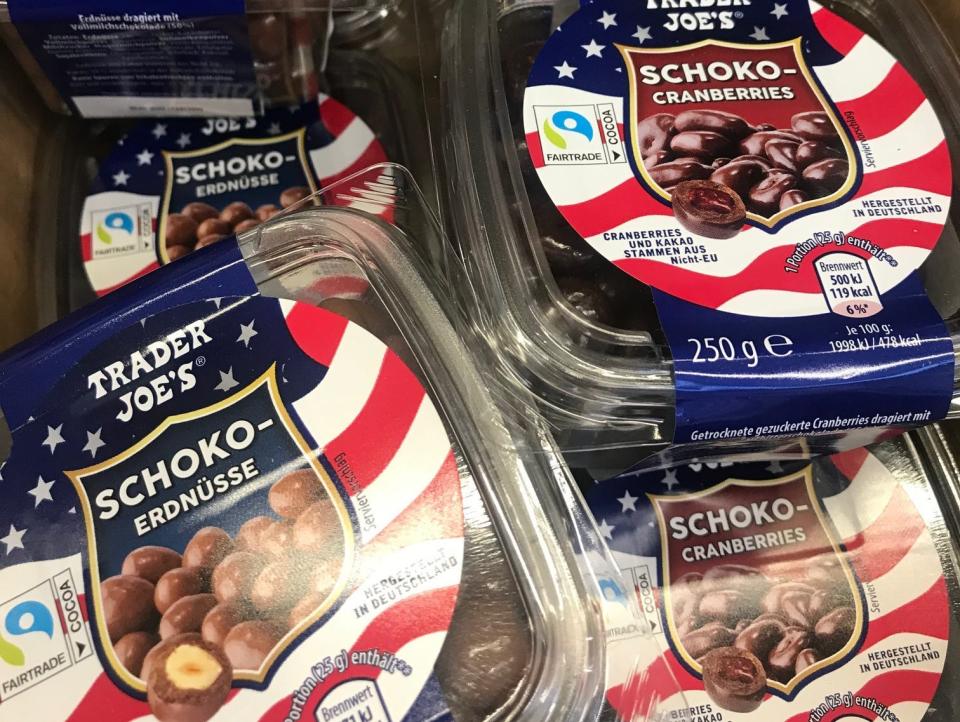 Chocolate covered hazelnuts and cranberries in clear packages with American flag on label at Spanish supermarket