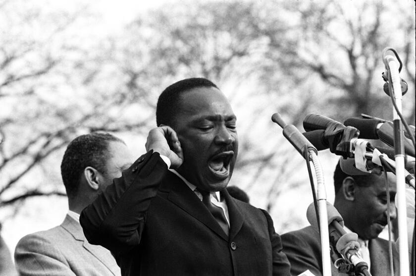 Dr. Martin Luther King, Jt. delivers his speech, “How Long, Not Long” on the steps of the Alabama State Capitol in Montgomery. Selma to Montgomery March. March 25, 1965. (Photo by Morton Broffman/Getty Images)