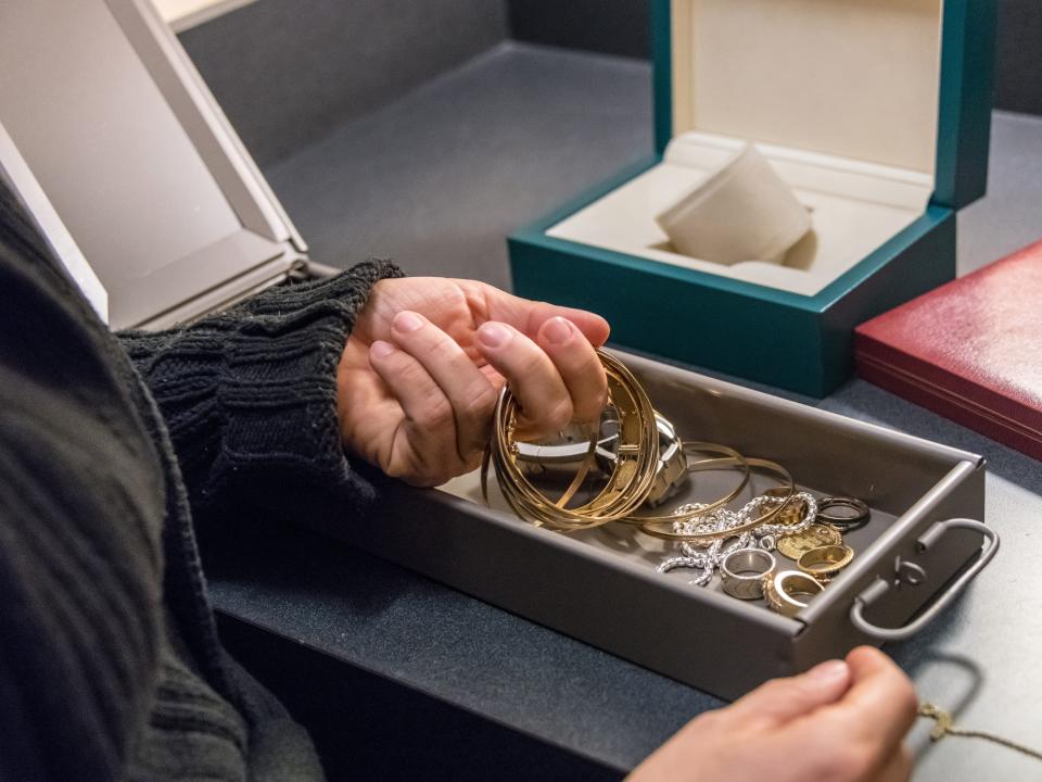 Woman Keeping her jewelry in a bank safe box - stock photo