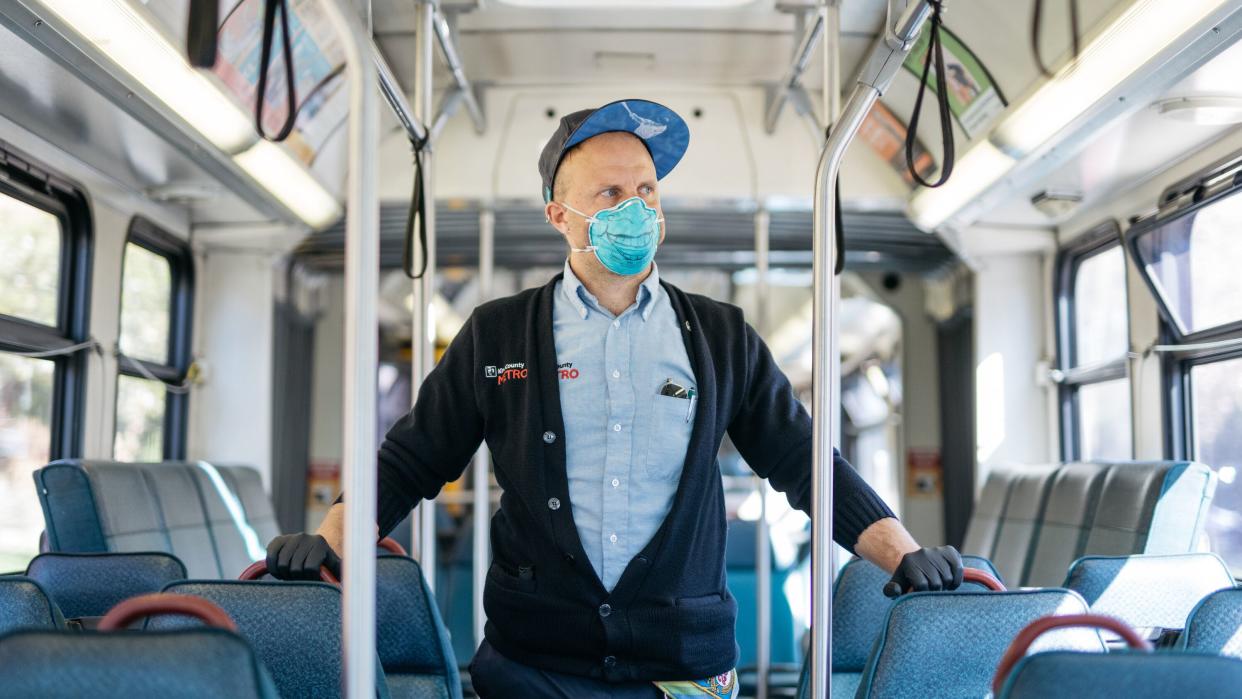 King County Metro bus driver Sam Smith poses for a portrait while on a break in Seattle on April 8, 2020. Smith is still driving amid the novel coronavirus crisis, utilizing a mask the bus service gave him two years ago during a particularly heavy, smoky fire season. (Photo: Grant Hindsley for HuffPost)