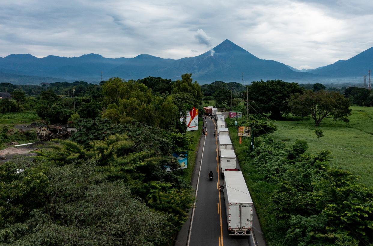 A long line of commercial trucks that were headed south on Highway 2 are stranded near Santa Cruz Muluá, Guatemala on Oct. 8, 2023.