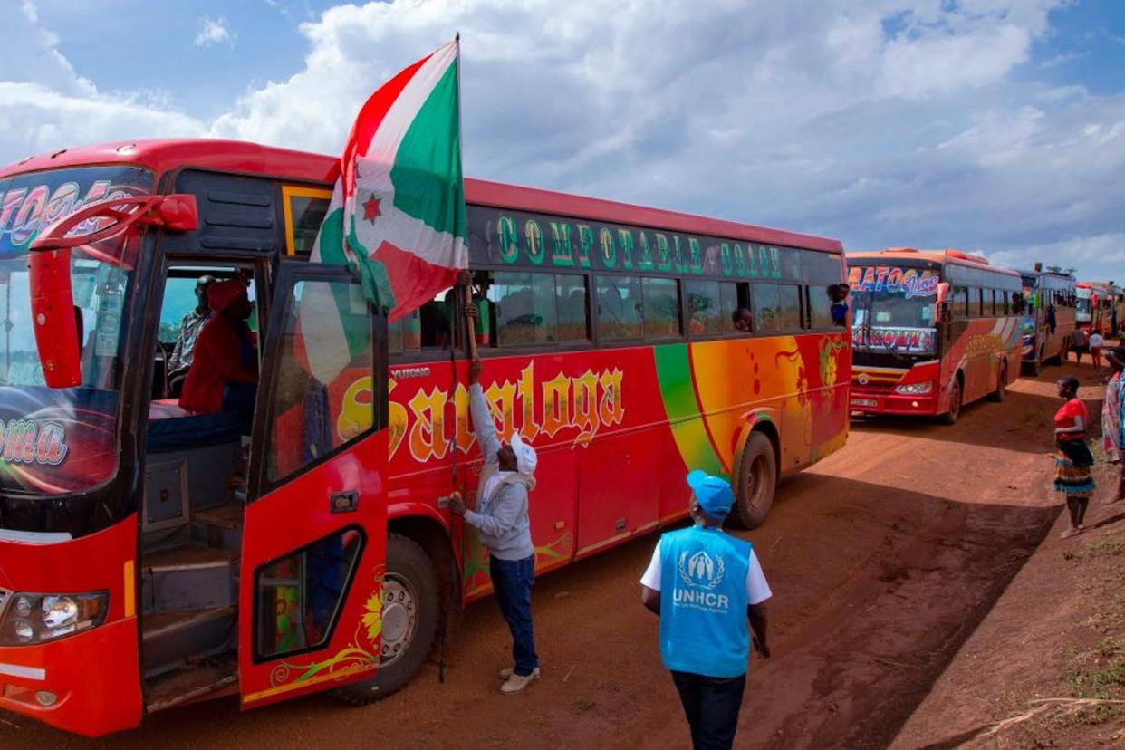 The Burundian flag flies at the head of a convoy of buses moving refugees back home from Tanzania in 2019. Tchandrou Nitanga/AFP via Getty Images